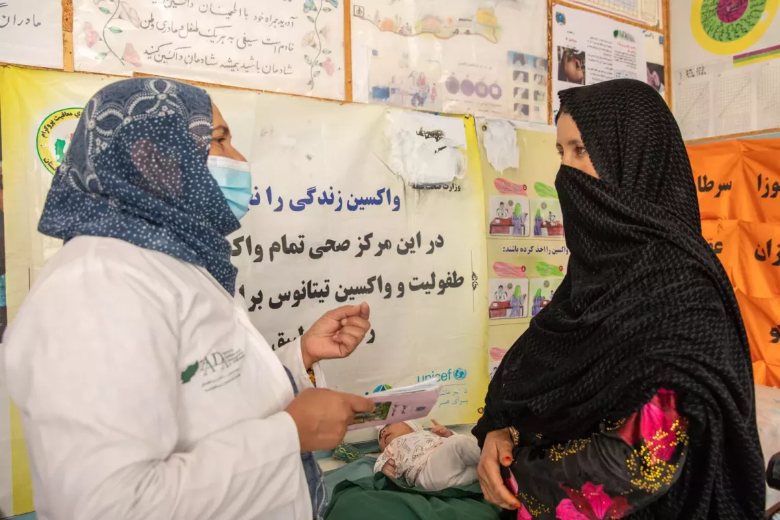 On 14th of April 2025, Karima Azimi is talking with 50-day-old Binyamin&rsquo;s grandmother Kubra at Rawashan CHC. Kubra brought her grandson for his second-round childhood vaccine. Karima has been working as fixed vaccinator at Rawashan health facility in Injil district of western Herat province. On average, she is vaccinating 50-55 children on daily basis.