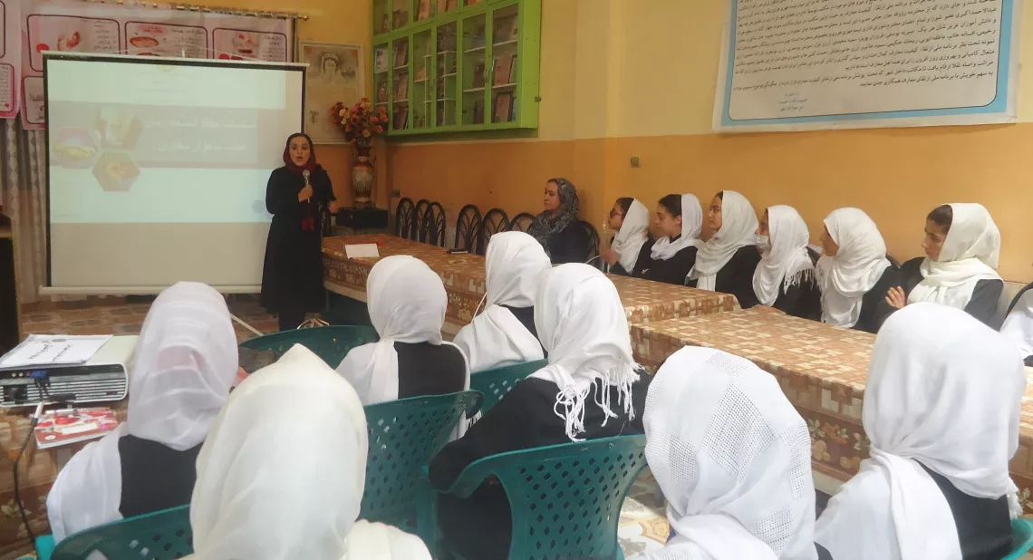 Khatera, 32, a mathematics teacher and volunteer health focal point, conducts a Menstrual Hygiene Management training at a school in Herat