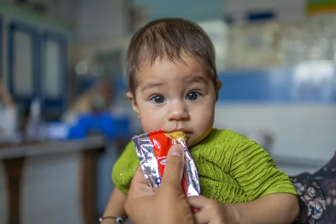  &nbsp; Satayesh eating RUTF during her second week of treatment after gaining 0.5 kilograms. 