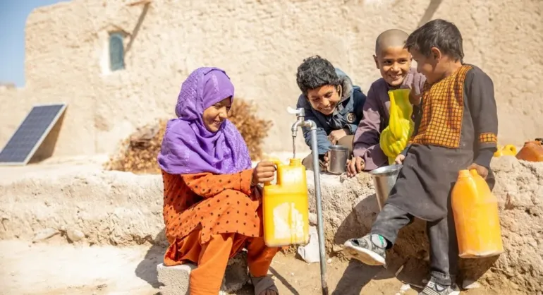11-year-old Rozia fills a jerrycan from the water tap at home, part of a new piped water system in her village in Farah, western Afghanistan. 