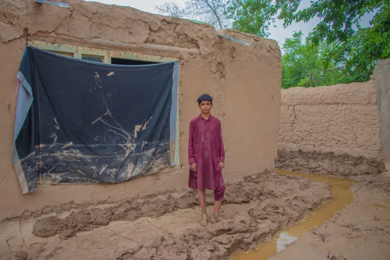  12-year-old Navid is photographed outside his flooded family home in Baghlan province, Afghanistan. His family and himself were affected by the recent flash floods in northern Afghanistan.