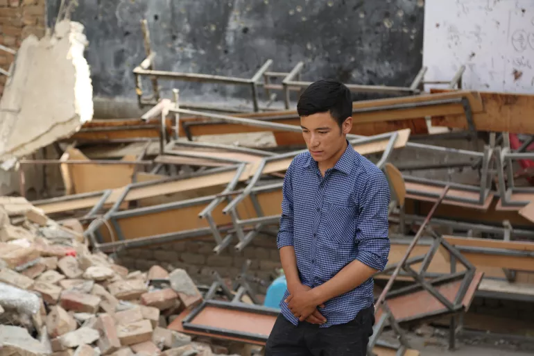 Nematullah, stepping into his classroom after the attack. 