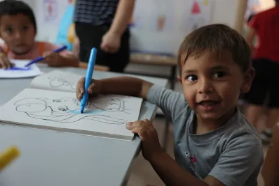 little boy drawing and smiling