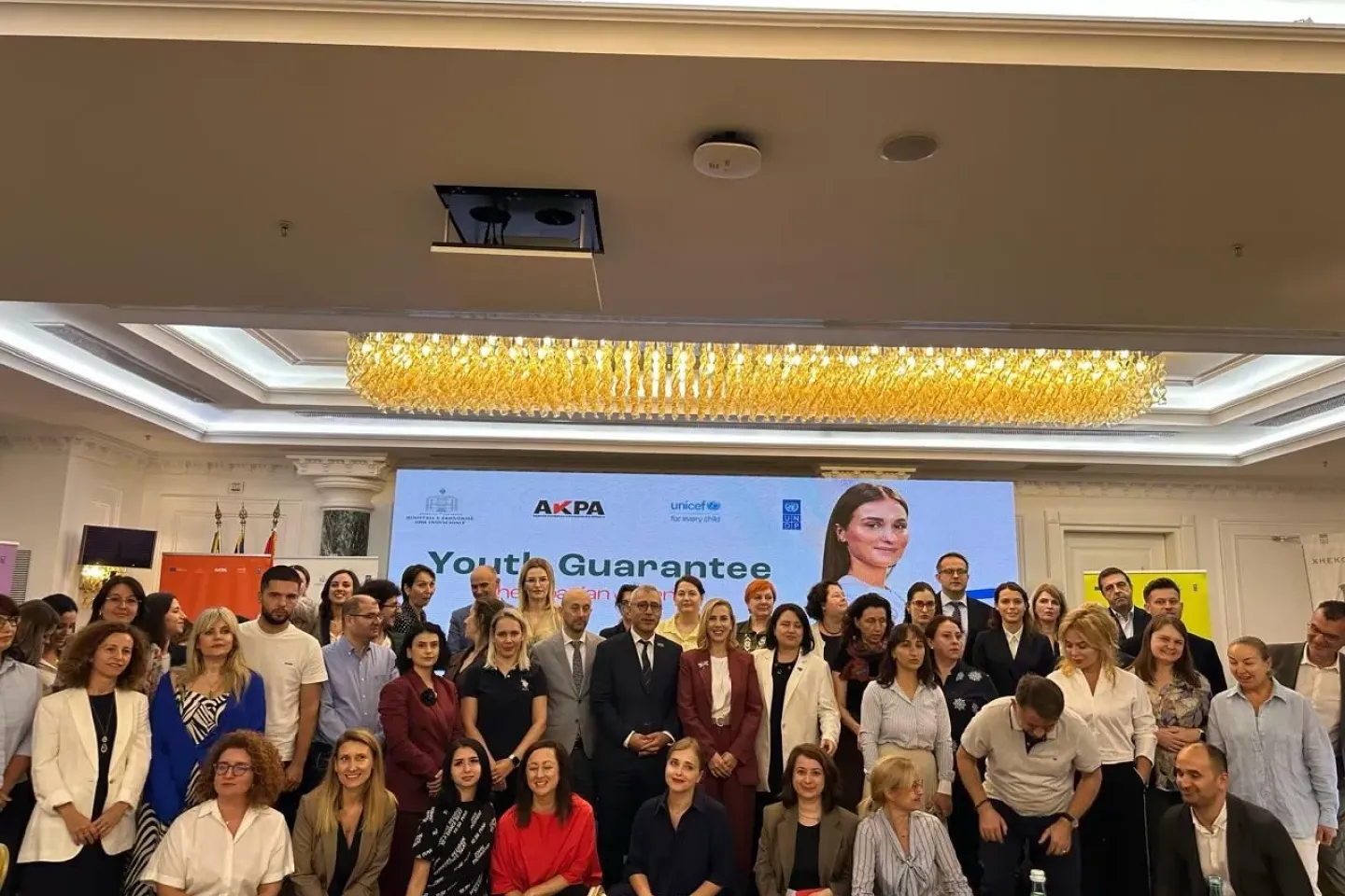 a big group of people at a confernece posing for a photo during youth guarantee workshop