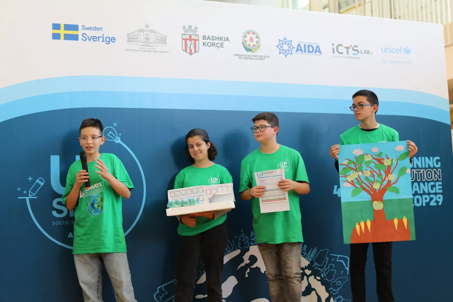 A team of adolescents pitching their idea in Upshift