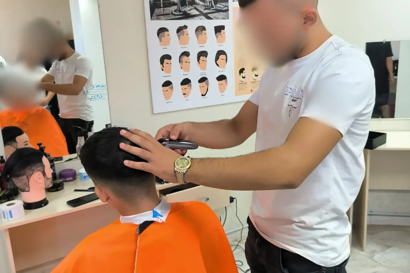 Young hairdresser guy cutting the hair of another boy