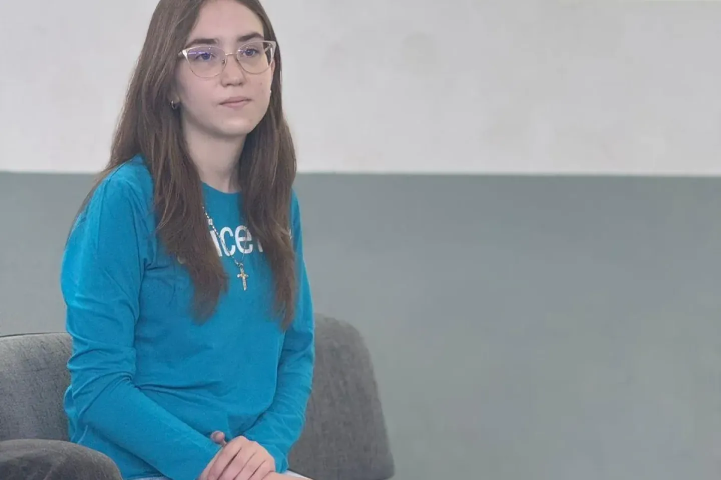 amelia standing on a chair holding a notebook in her hands