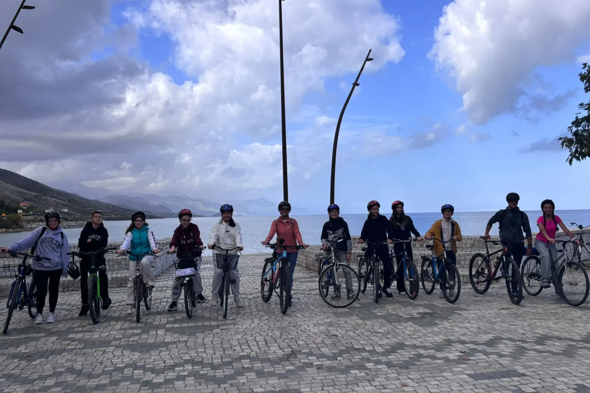 Youth in bike posing in front of a lake