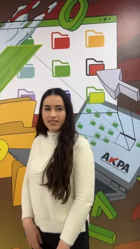 artjola posing infront of a branded wall