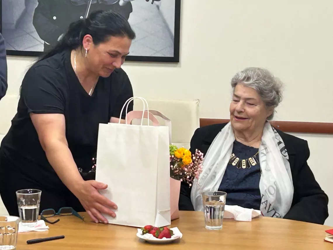 UNICEF presenting  Mrs. Xhepa with a present
