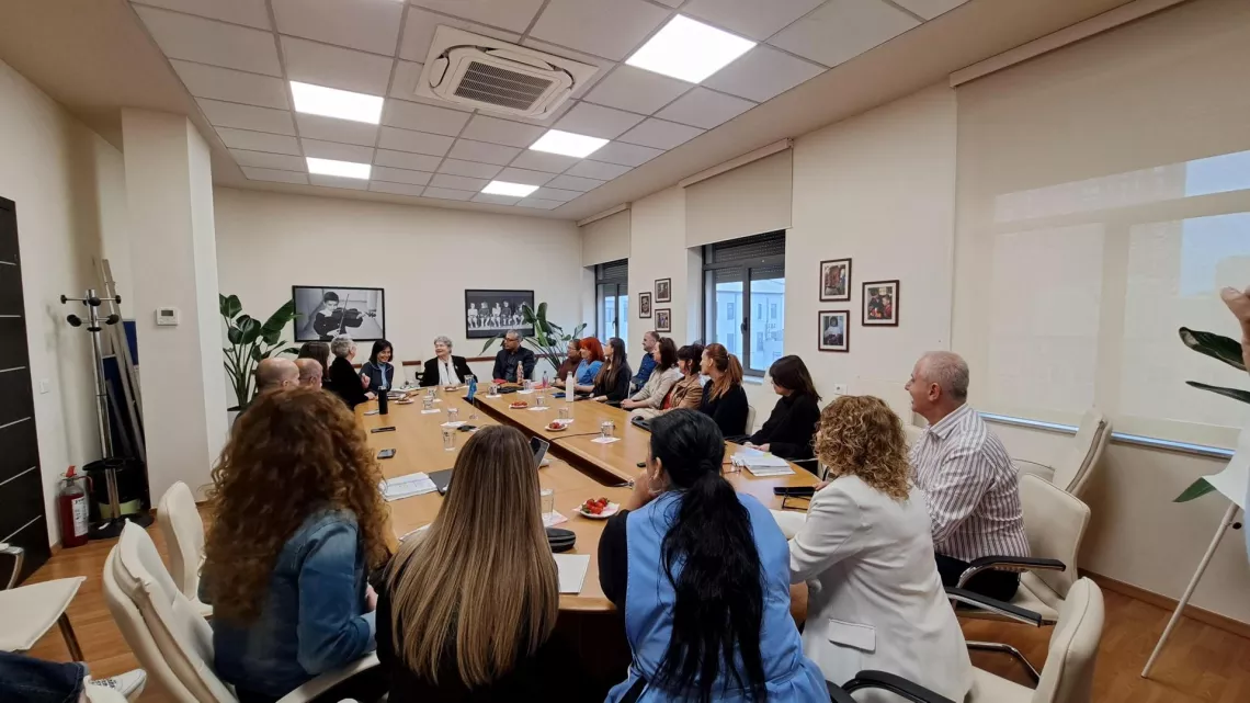 A big roundtable with people discussing around it