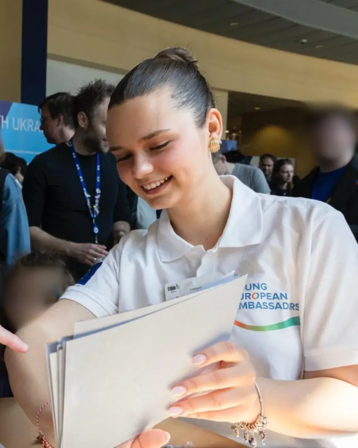 girl smiling with documents in her hands