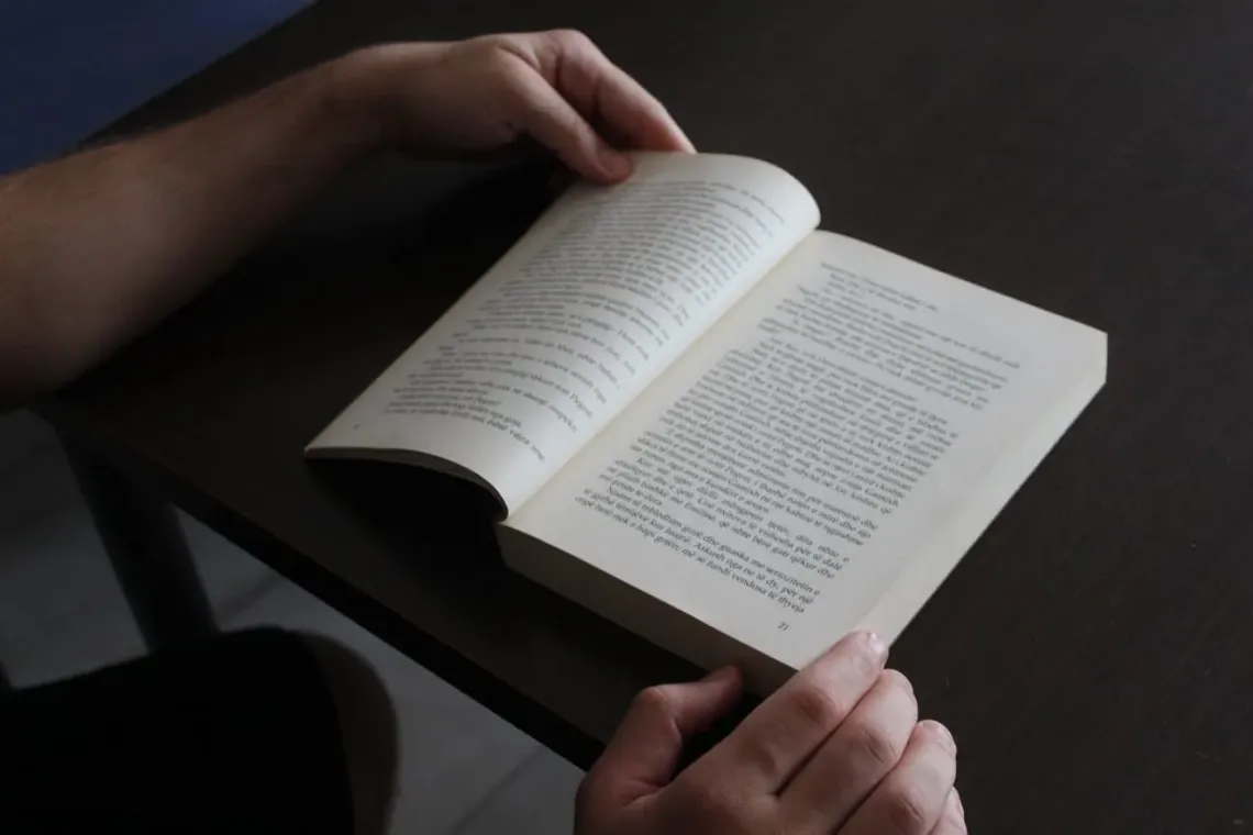 a book and two hands holding it