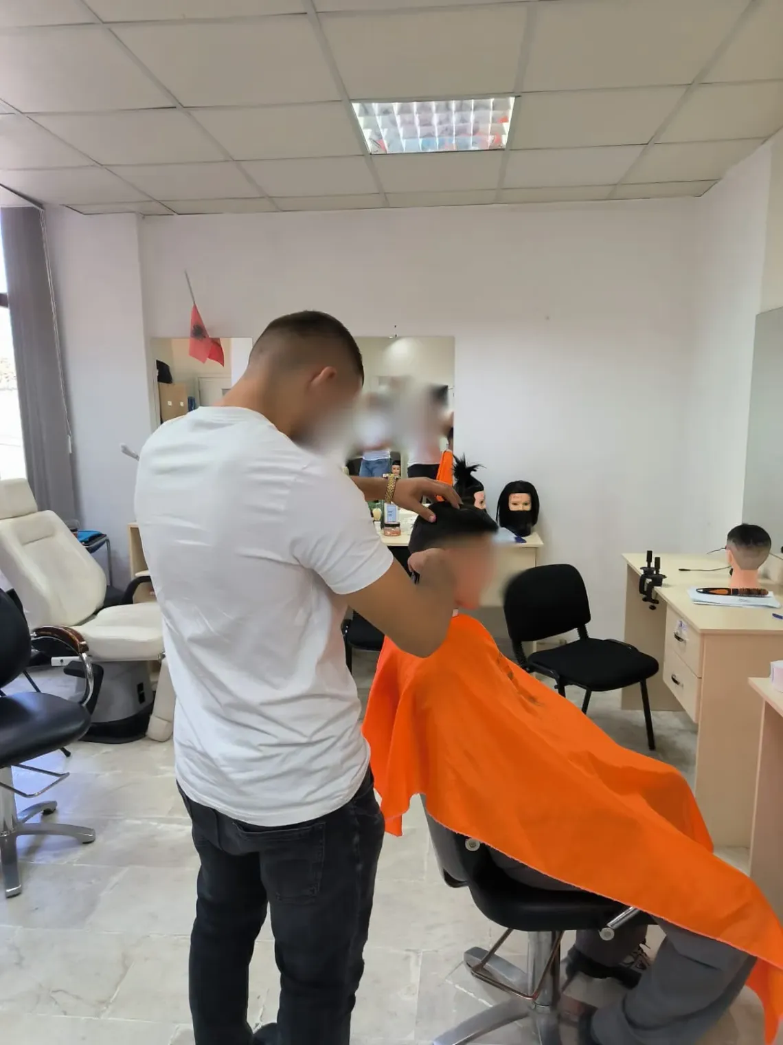 young hairdresser guy cutting the hair of another guy