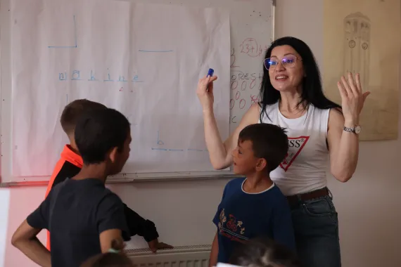 teacher in classroom with two young boys