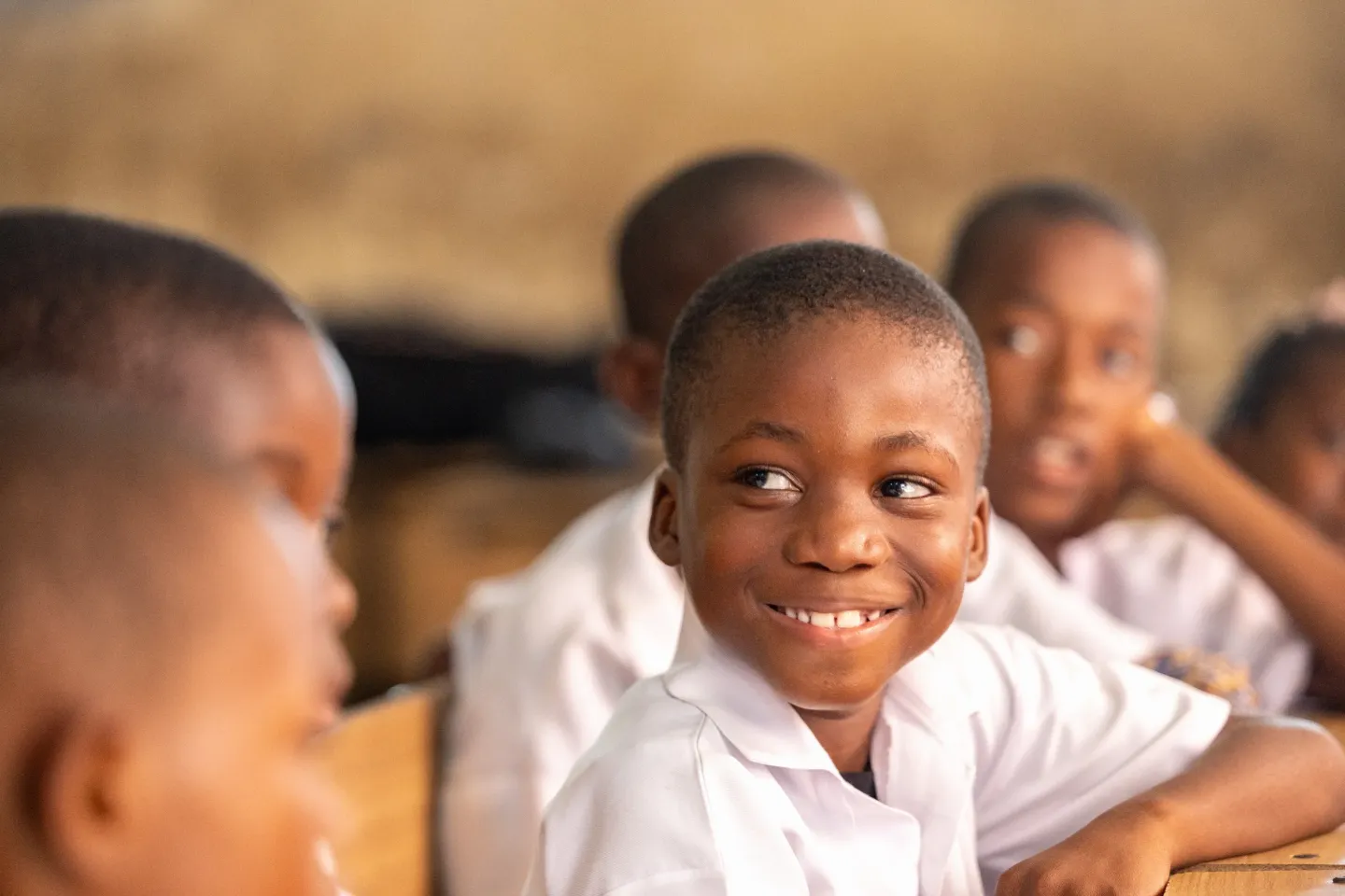 Boy smiles to camera in a classroom in Cacuaco Municipality, Luanda Province. 