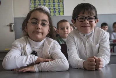 A boy and a girl sitting together in a classroom in the inclusive school in Armenia.