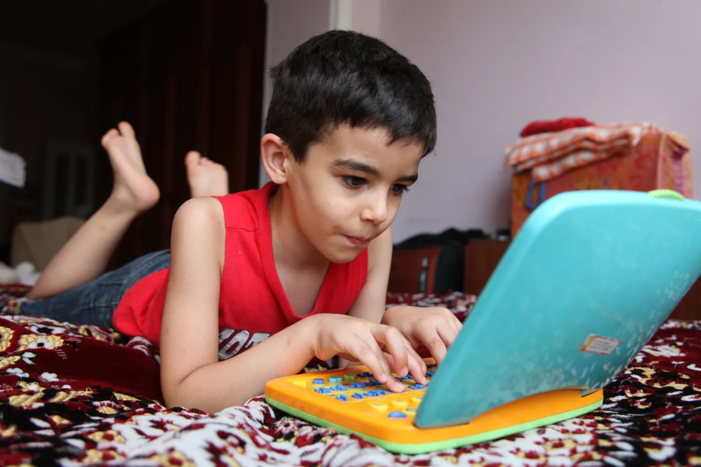 Agassi, 6 year old, working on toy computer.