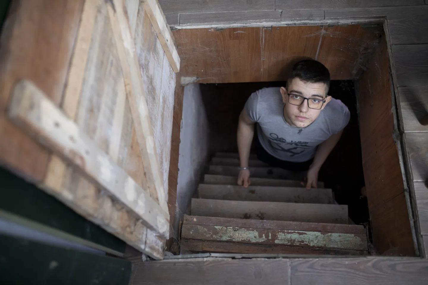 An adolescent is hiding in the shelter at the house. 