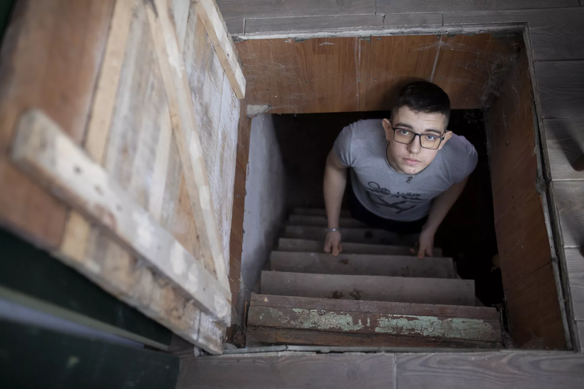 An adolescent is hiding in the shelter at the house. 