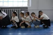 Arpi and her classmates are doing physical exercises in the school.