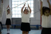 Arpi and her classmates are doing physical exercises in the school.