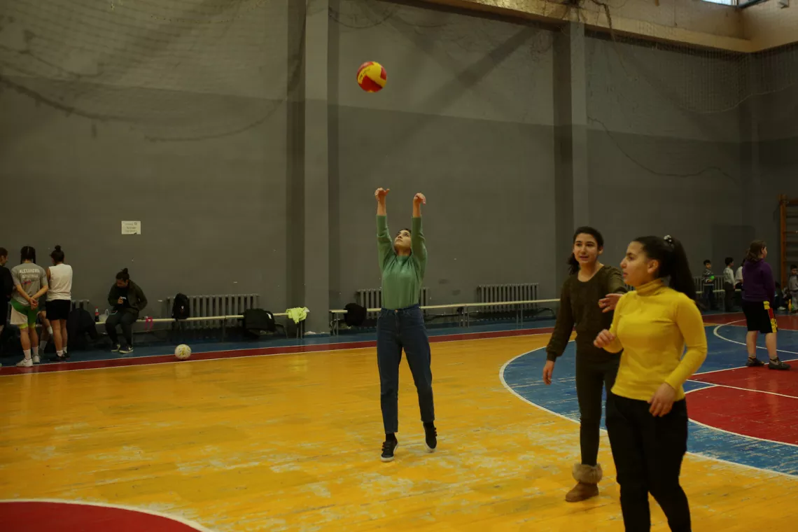 Anna is playing with ball.