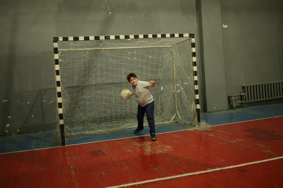 Vladimir is playing football with other children from Yerevan and NK. 