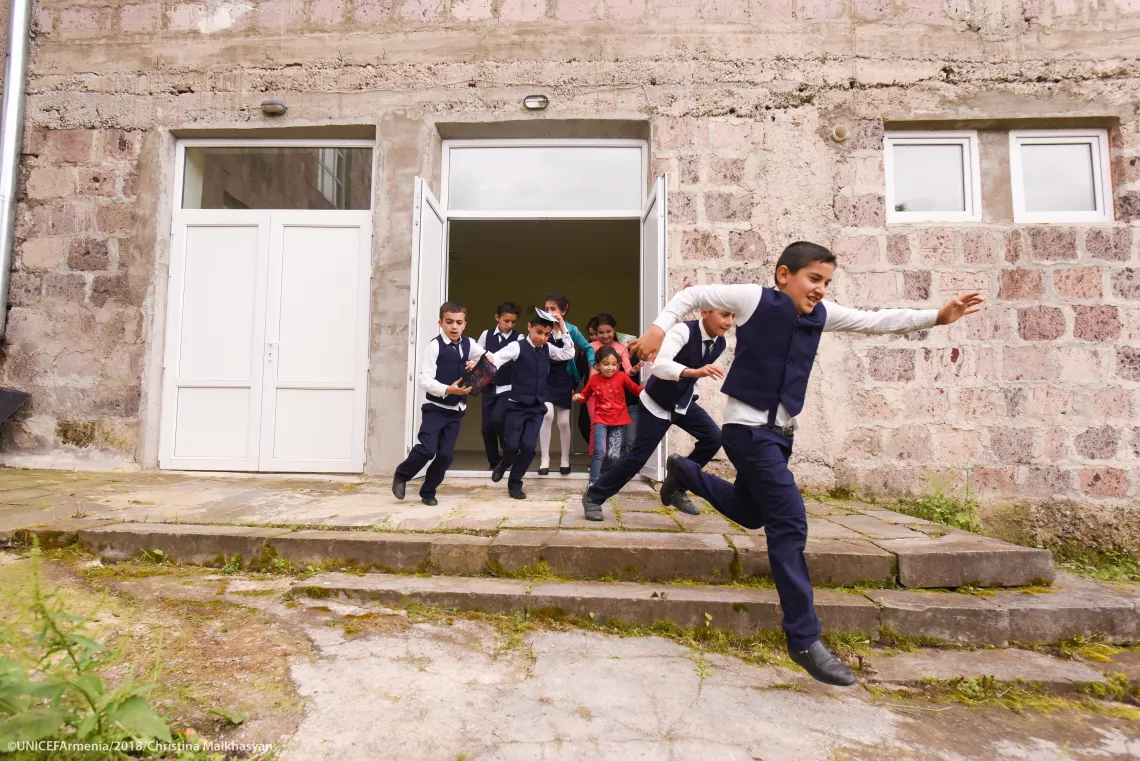 Children are running out from the school of Nerqin Tsakhkavan border village during the evacuation drill.