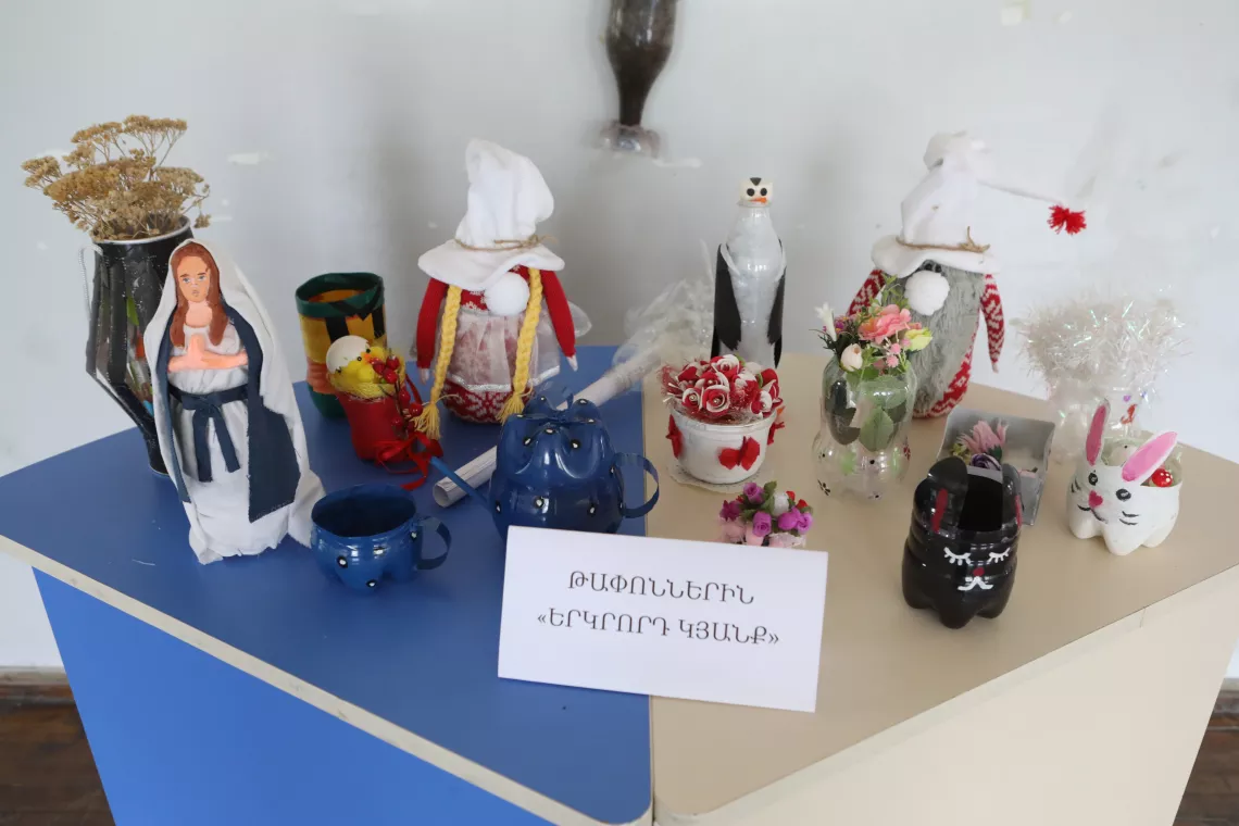 A group of children has repurposed waste materials and transformed them into new objects.