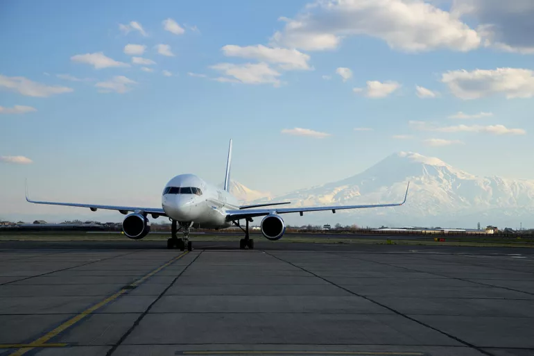 An airplane in the background of Mount Ararat. 2nd batch of C-19 vaccines received.