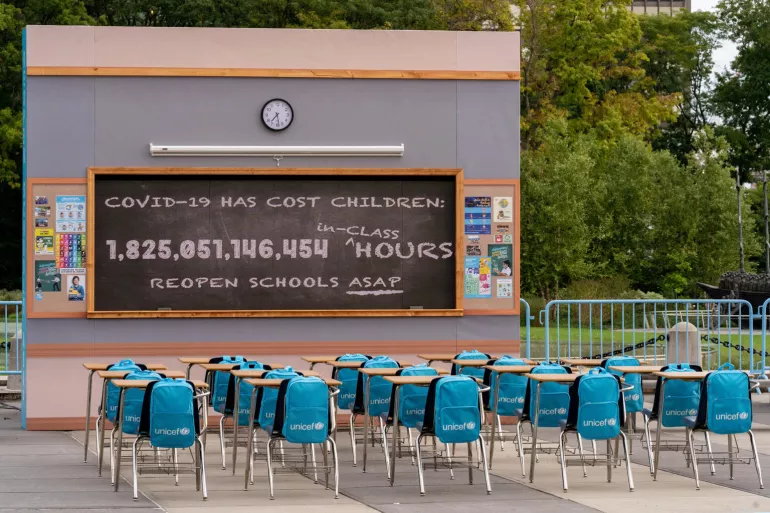 Installation of a classroom with a clock and blackboard outside the General Assembly in NY