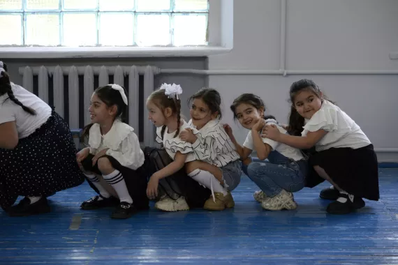 Arpi and her classmates are doing physical exercises in the school.