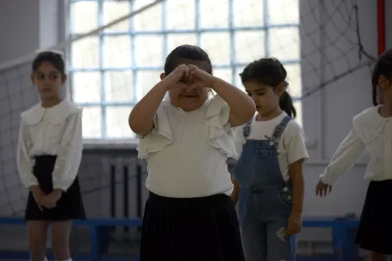 Arpi and her classmates are doing physical exercises in the school.