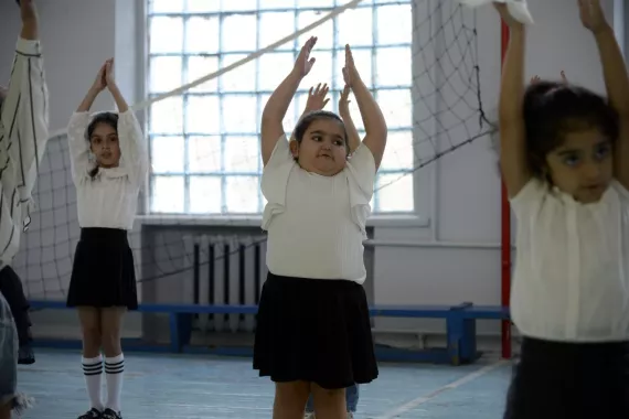 Arpi and her classmates are doing physical exercises in the school.