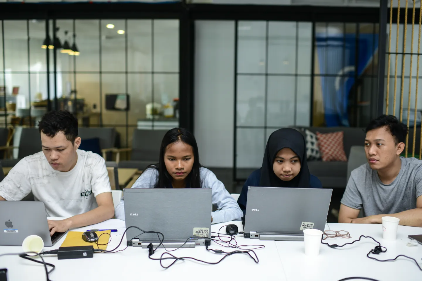 Youth sitting together on their computers