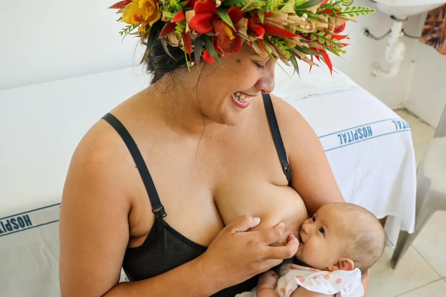 A mother looks lovingly while nursing her baby