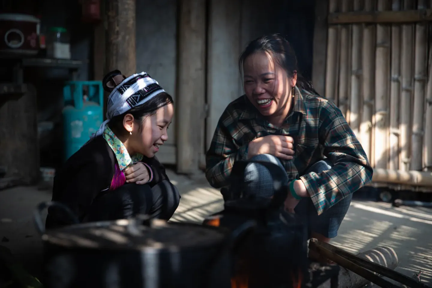 A girl and her mother laughing together