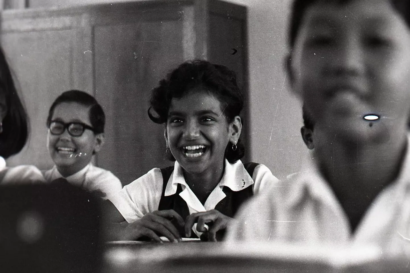 A smiling girl sitting in the classroom