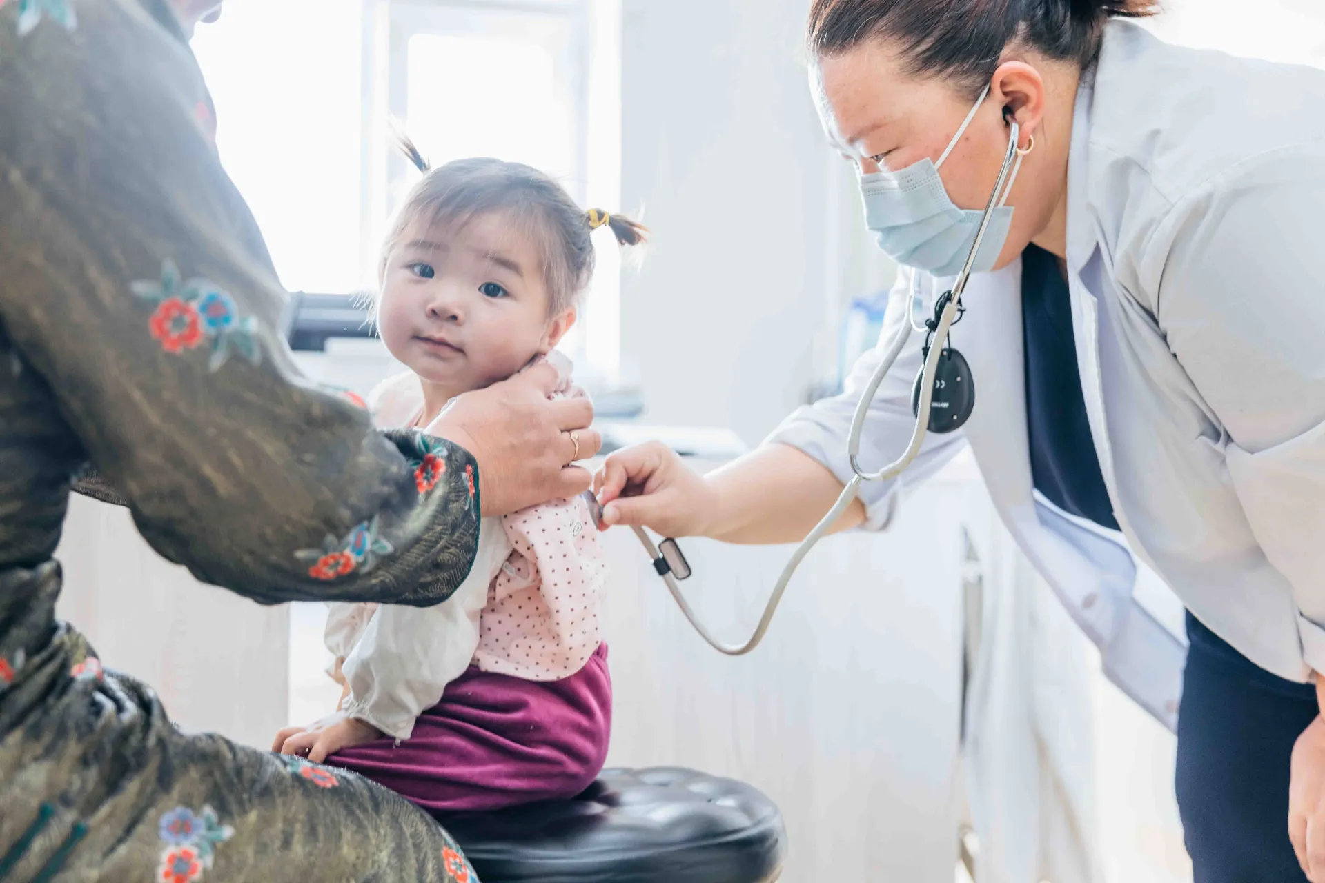 A little girl with pigtails gets a checkup