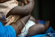 A Child sits on mother's lap