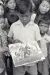 In 1980 in Kampuchea [now Cambodia], a boy in a camp for people displaced by civil conflict shows one of his drawings, which reflects some of the trauma he has experienced. Children who have been uprooted by man-made or natural disasters often bear serious psychological scars.