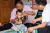  village doctor Zhao Yongsheng visits Li Xiuxiang and her one-and-a-half-year-old grandson, Wenfeng, at their home, teaching Li Xiuxiang how to play with Wenfeng. 