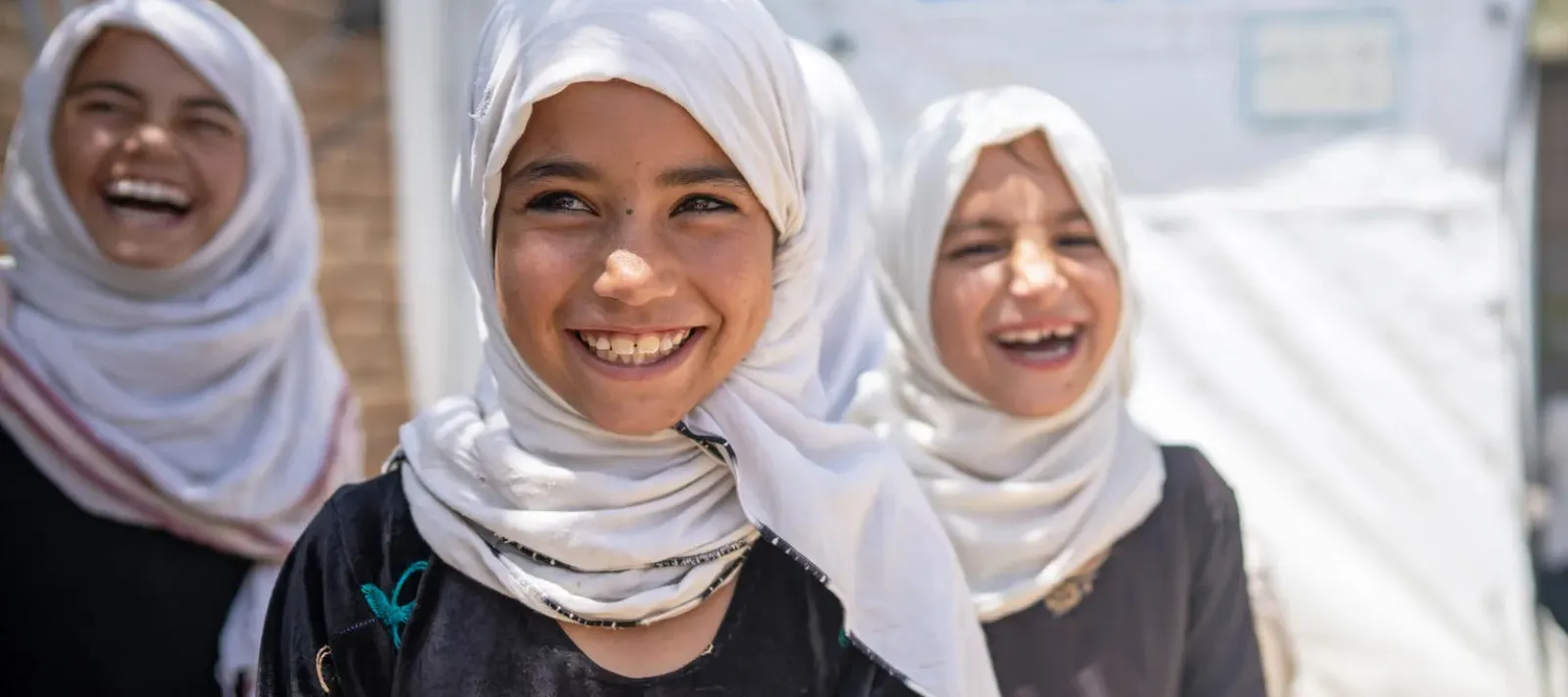 Three children smiling.