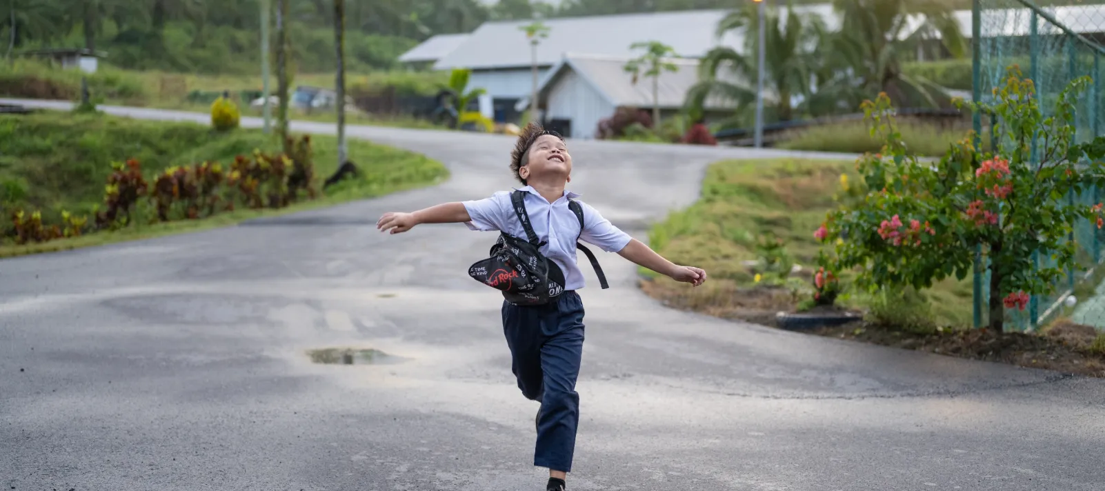 Boy running down a wet street