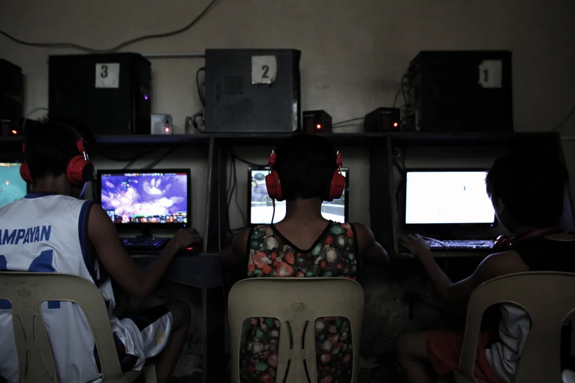 Kids sitting at computers playing video games