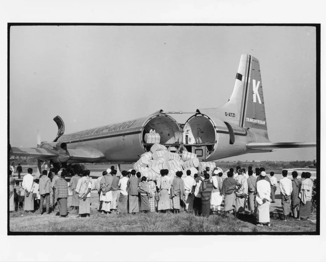 unloading cargo from a plane, Bangladesh 1972