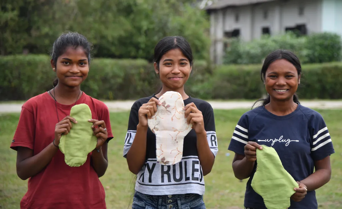 Members of the adolescent girls club hold sanitary pads
