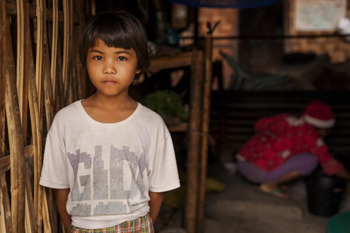 a child stands in a doorway