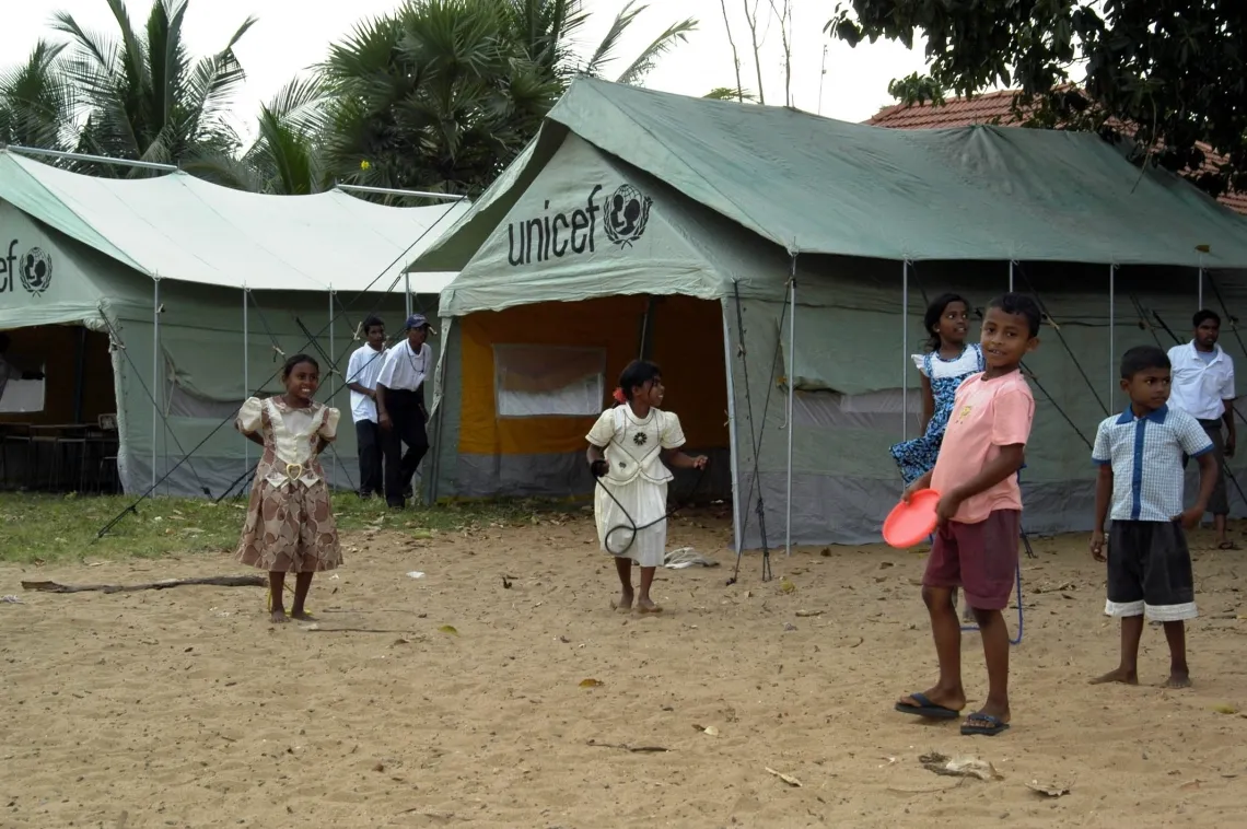 Children playing in front of UNICEF tents.